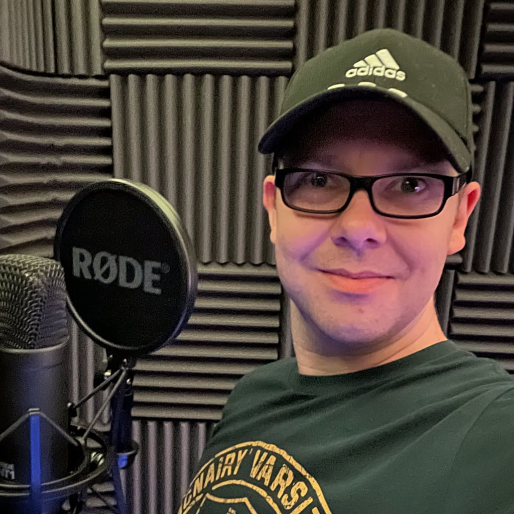 James Marshall standing in his recording studio looking at the camera, next to a microphone